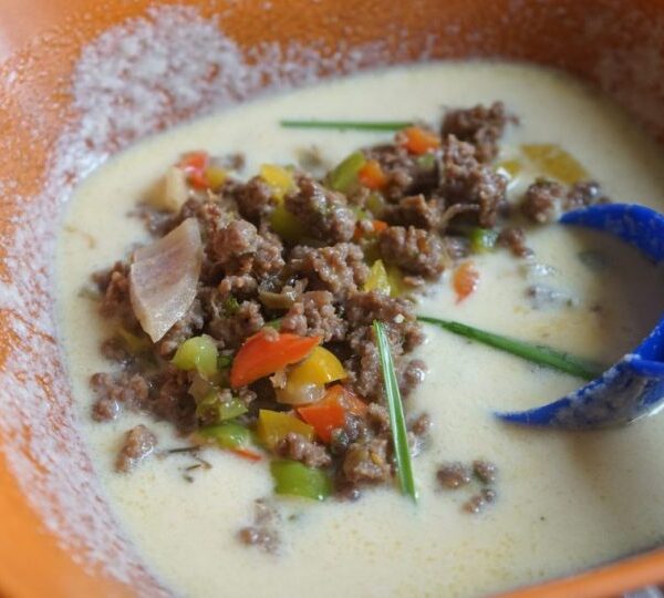 Here are some alternative title rewrites:

Classic Semolina Pancakes with Savory Ground Meat
or
Homemade Meat-Stuffed Semolina Pancakes

The second version is particularly effective as it:
- Clearly states the dish name
- Uses "homemade" to appeal to those seeking authentic recipes
- Accurately describes the combination of ingredients
- Is concise yet informative
- Maintains professional tone